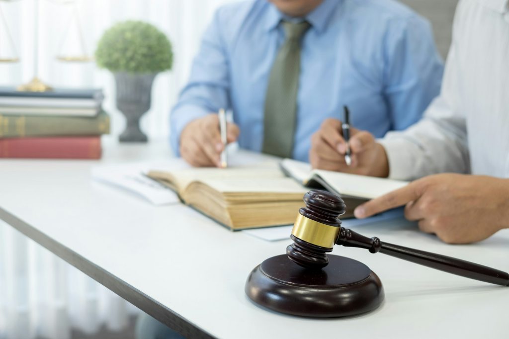 Lawyers team discuss legal matters to assist clients in legal litigation.